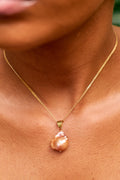 Àsàbí elegant and minimalist necklace featuring a single, genuine Mediterranean coral bead with a premium gold accent and chain.